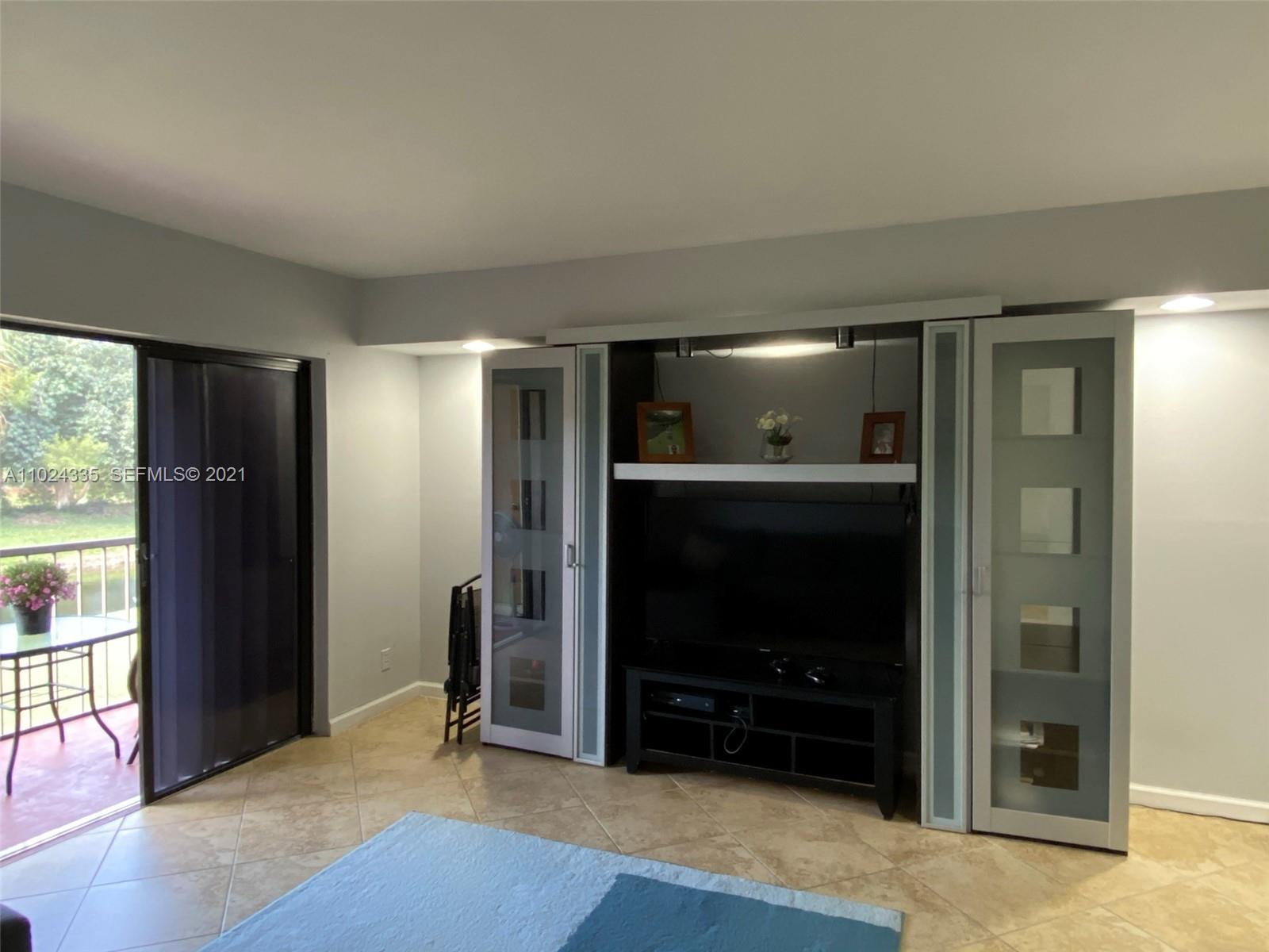 209 Lakeview Drive, Unit 202 Weston, FL 33326 - Photo 10 of 25 a view of a livingroom with a flat screen tv