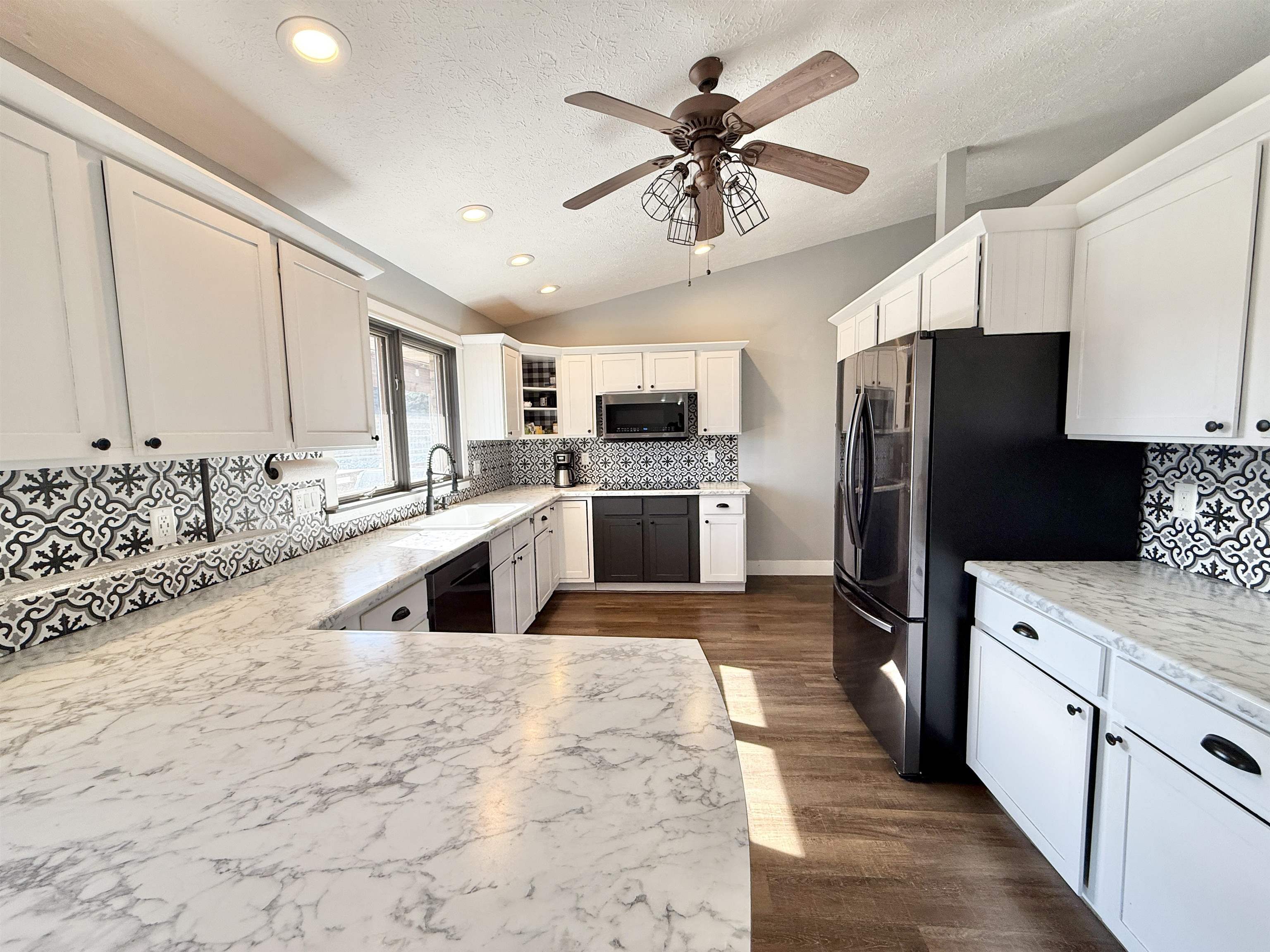 11245 Fox Trail Road Durand, IL 61024 - Photo 12 of 56 a kitchen with granite countertop a refrigerator a sink dishwasher a oven with a dining table and chairs