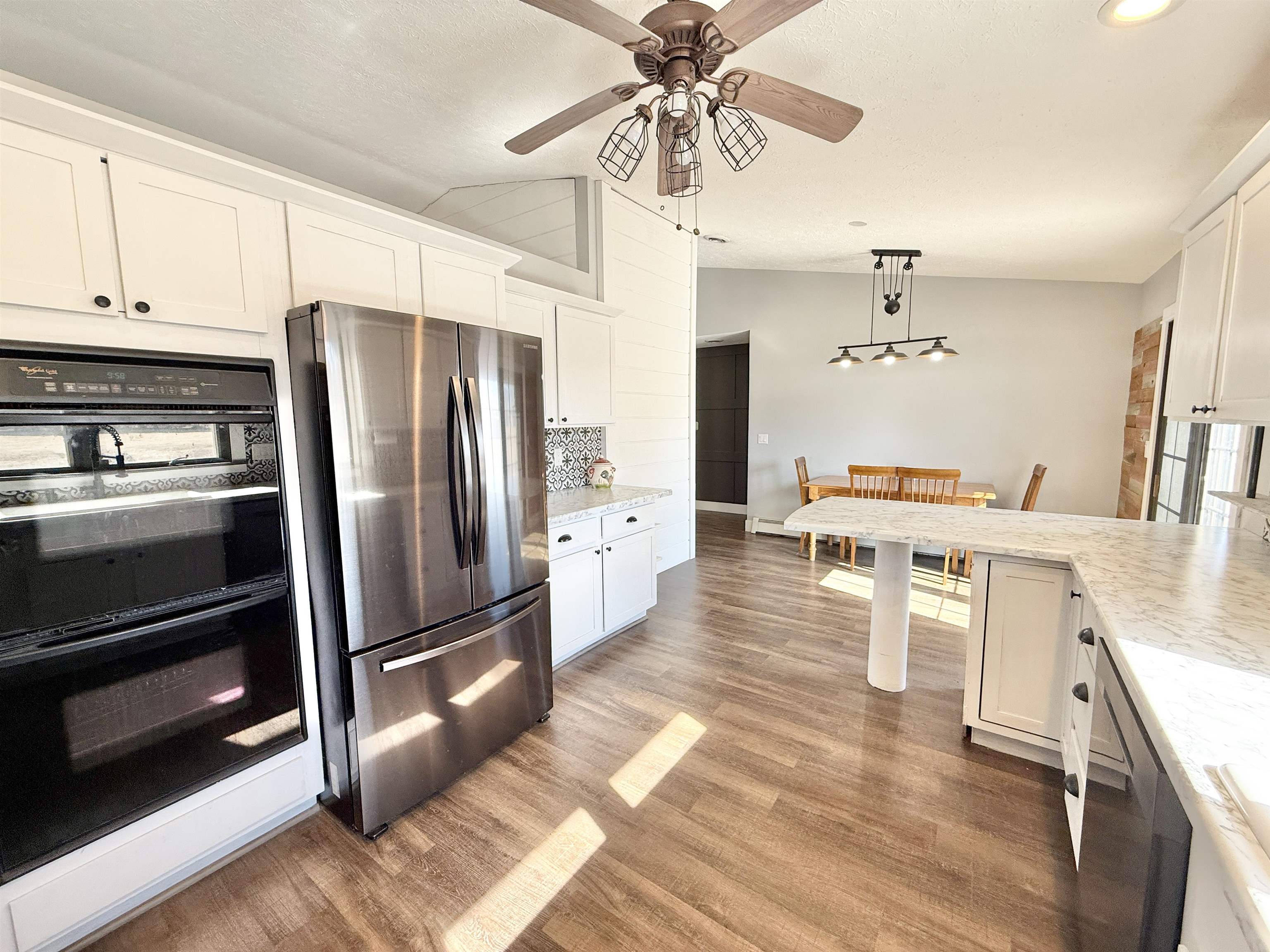 11245 Fox Trail Road Durand, IL 61024 - Photo 13 of 56 a kitchen with stainless steel appliances a stove a refrigerator and cabinets