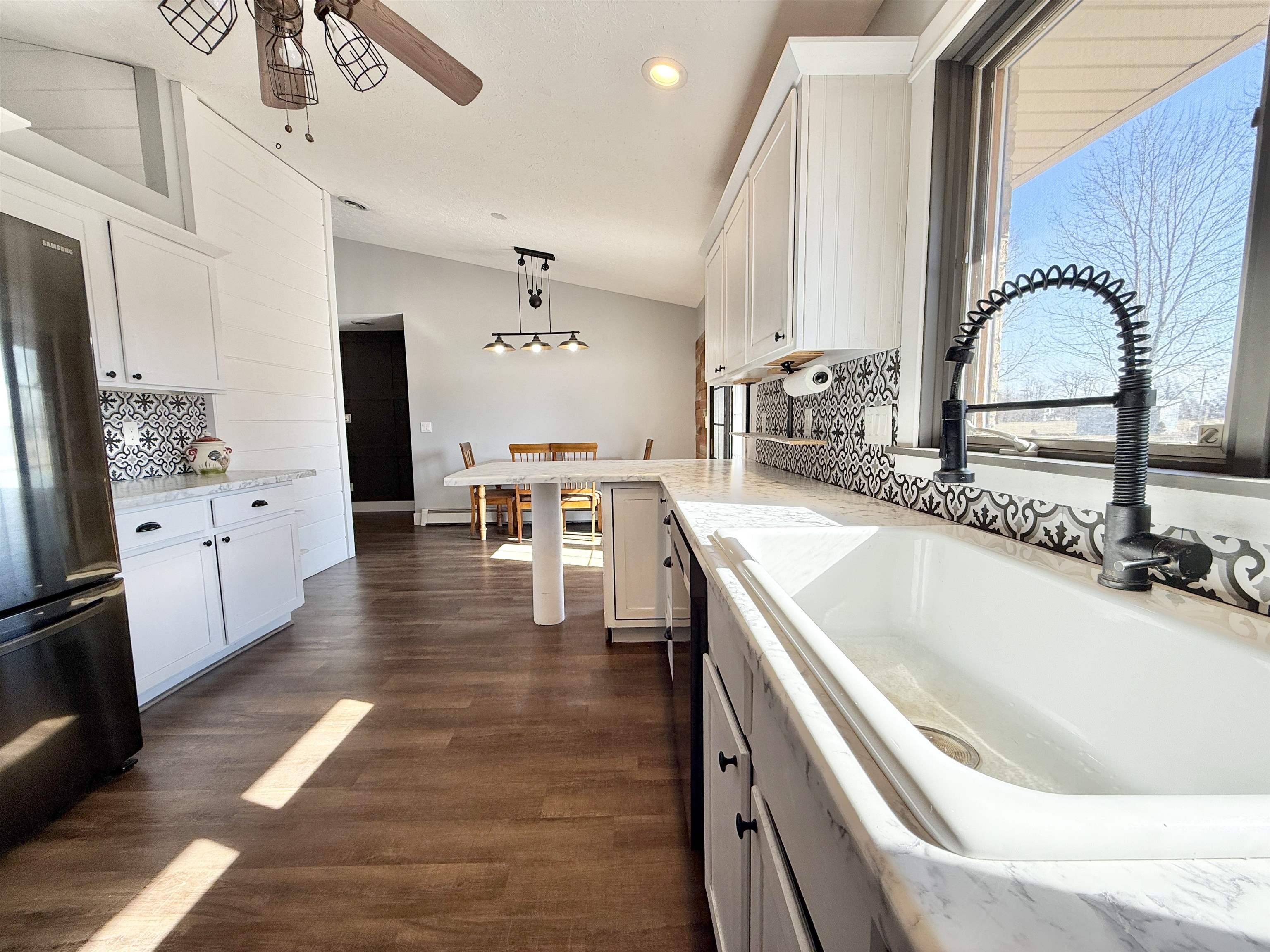 11245 Fox Trail Road Durand, IL 61024 - Photo 14 of 56 a large white kitchen with a large window a counter space and stainless steel appliances
