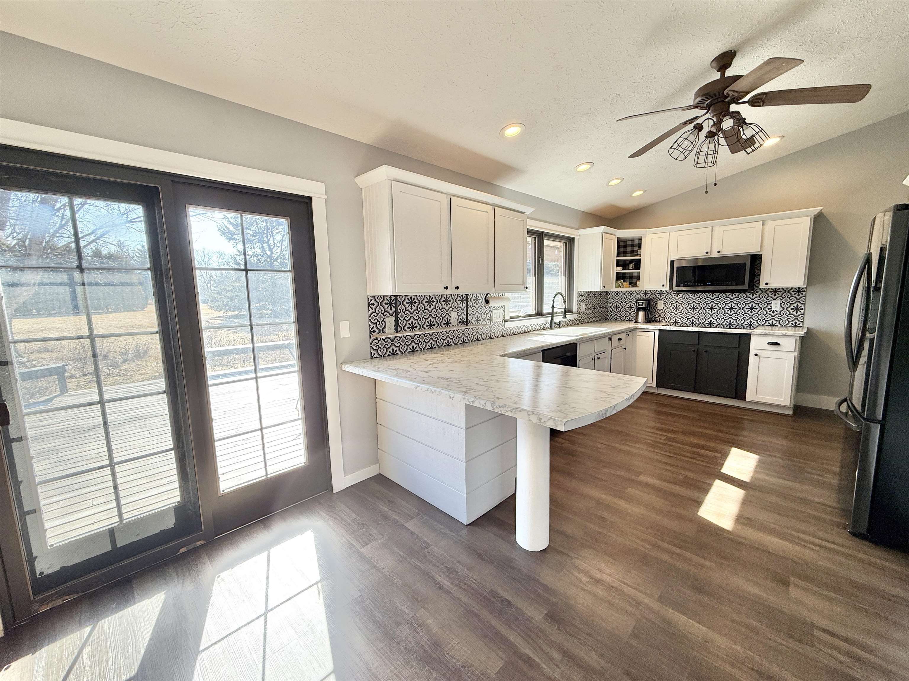 11245 Fox Trail Road Durand, IL 61024 - Photo 15 of 56 a large kitchen with kitchen island wooden floors and stainless steel appliances