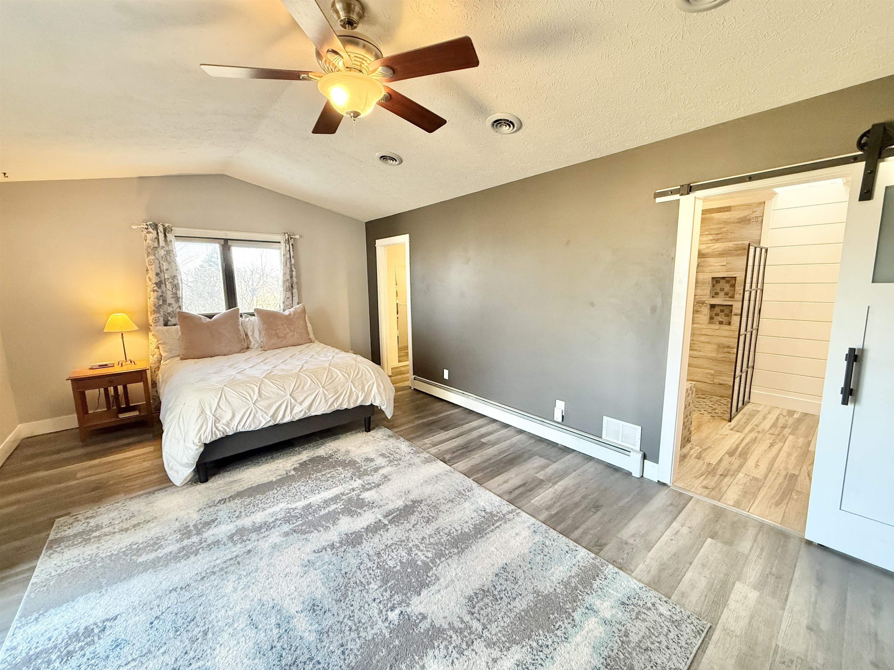 11245 Fox Trail Road Durand, IL 61024 - Photo 19 of 56 a bedroom with a large bed and a chandelier