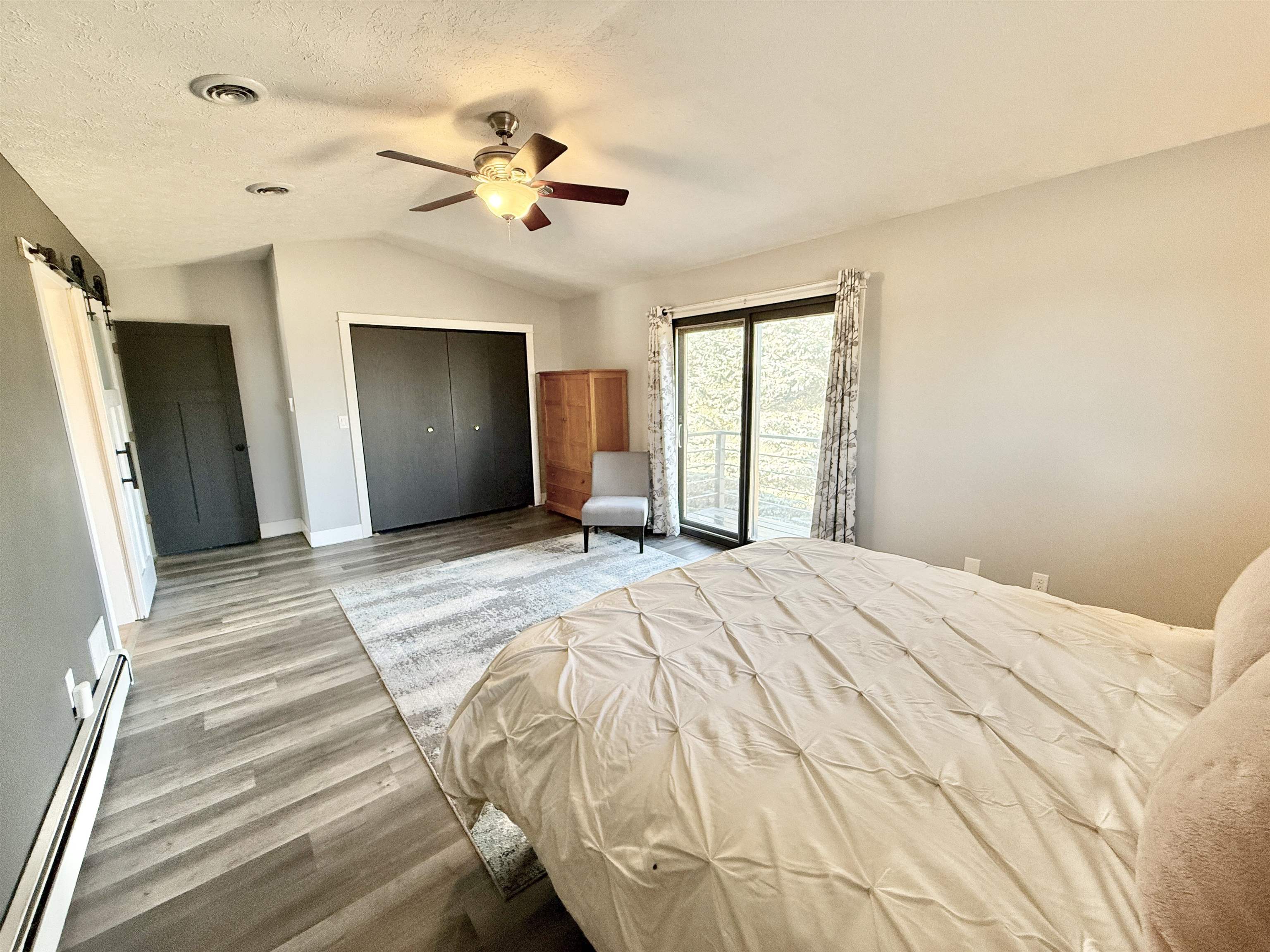 11245 Fox Trail Road Durand, IL 61024 - Photo 21 of 56 a bedroom with a bed and a chandelier