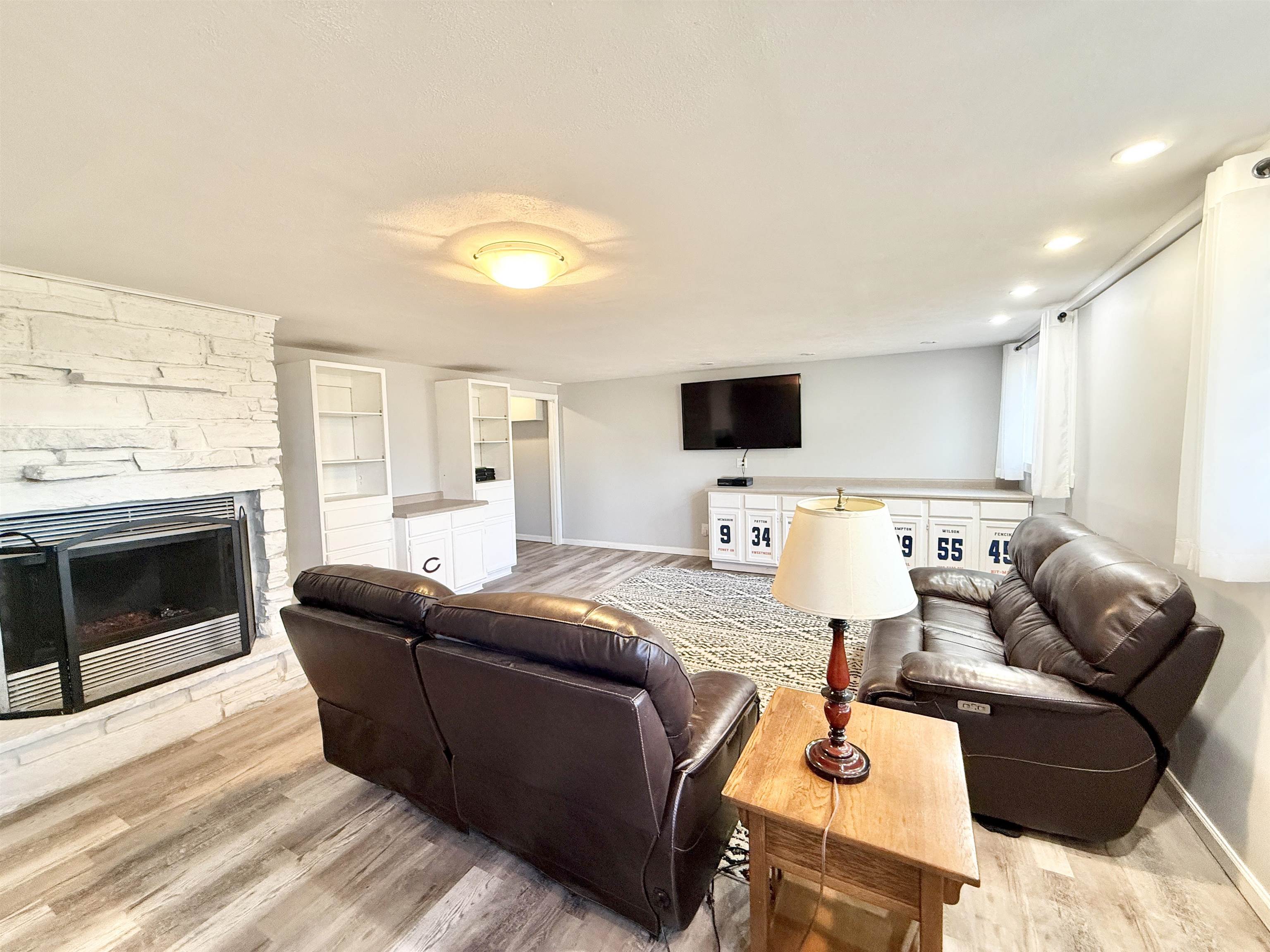 11245 Fox Trail Road Durand, IL 61024 - Photo 37 of 56 a living room with furniture a fireplace and a flat screen tv