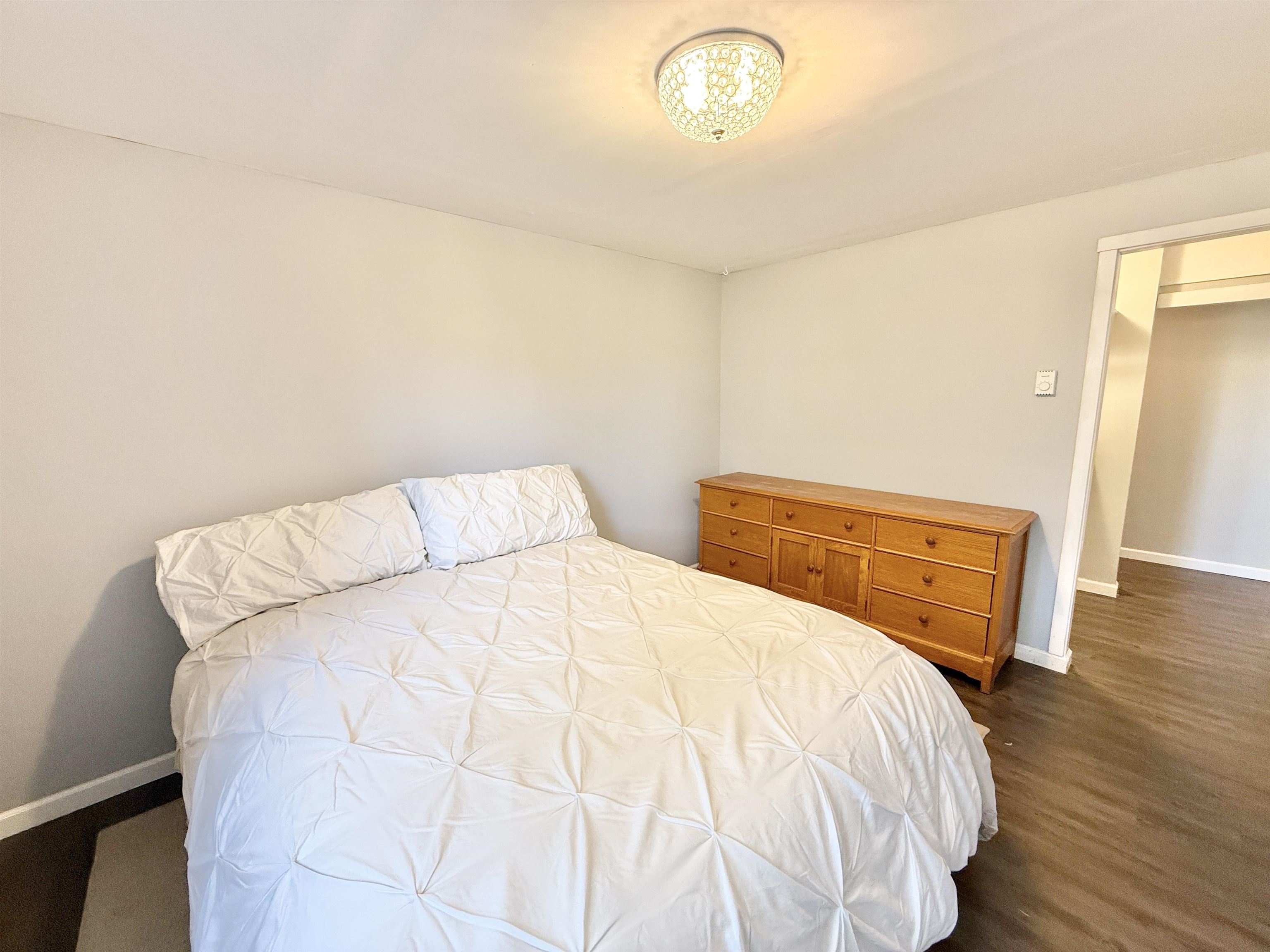 11245 Fox Trail Road Durand, IL 61024 - Photo 39 of 56 a bedroom with a bed and wooden floor