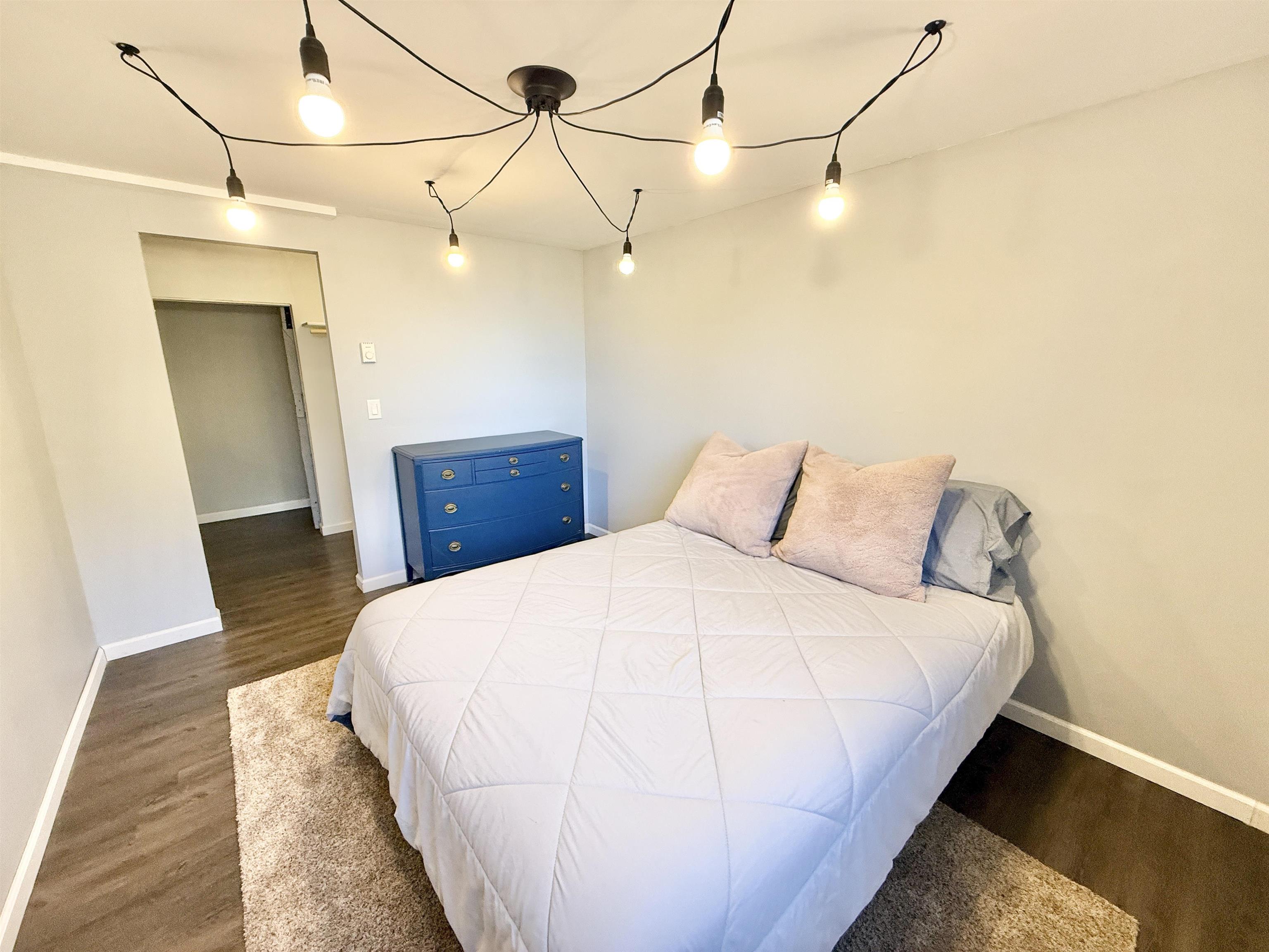 11245 Fox Trail Road Durand, IL 61024 - Photo 42 of 56 a large bed in a bedroom next to a wooden closet