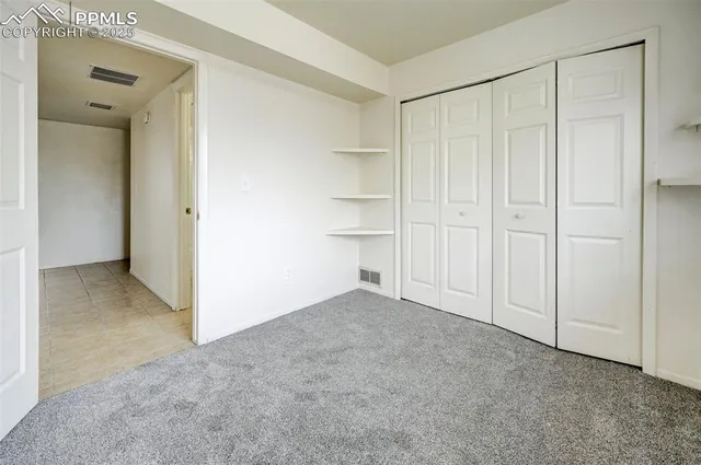 a view of an empty room and closet area