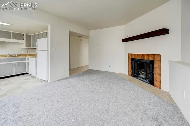 a view of an empty room with a fireplace