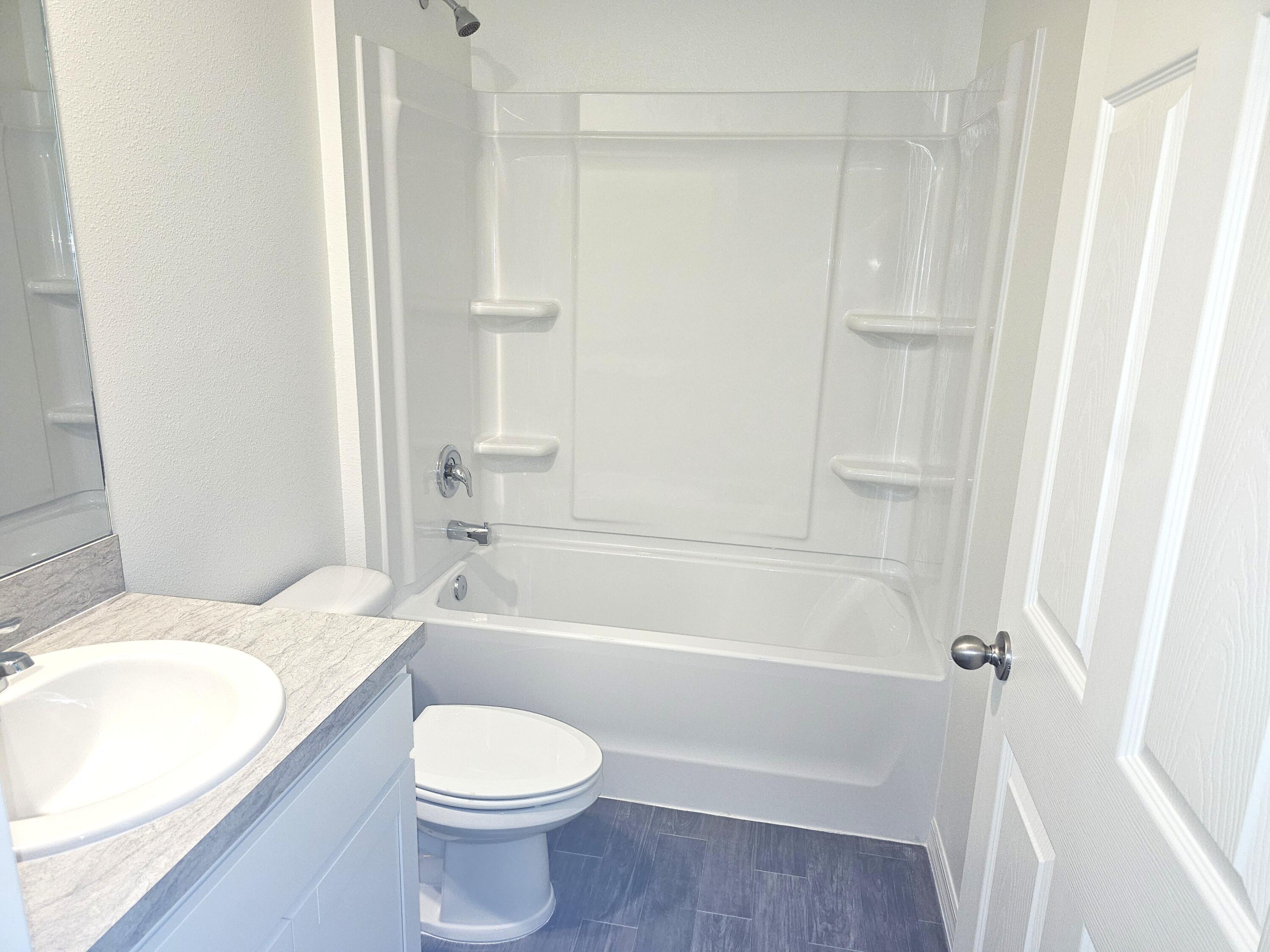 3681 Southwest Haines Street Port St. Lucie, FL 34953 - Photo 6 of 19 a bathroom with a toilet and a bath tub