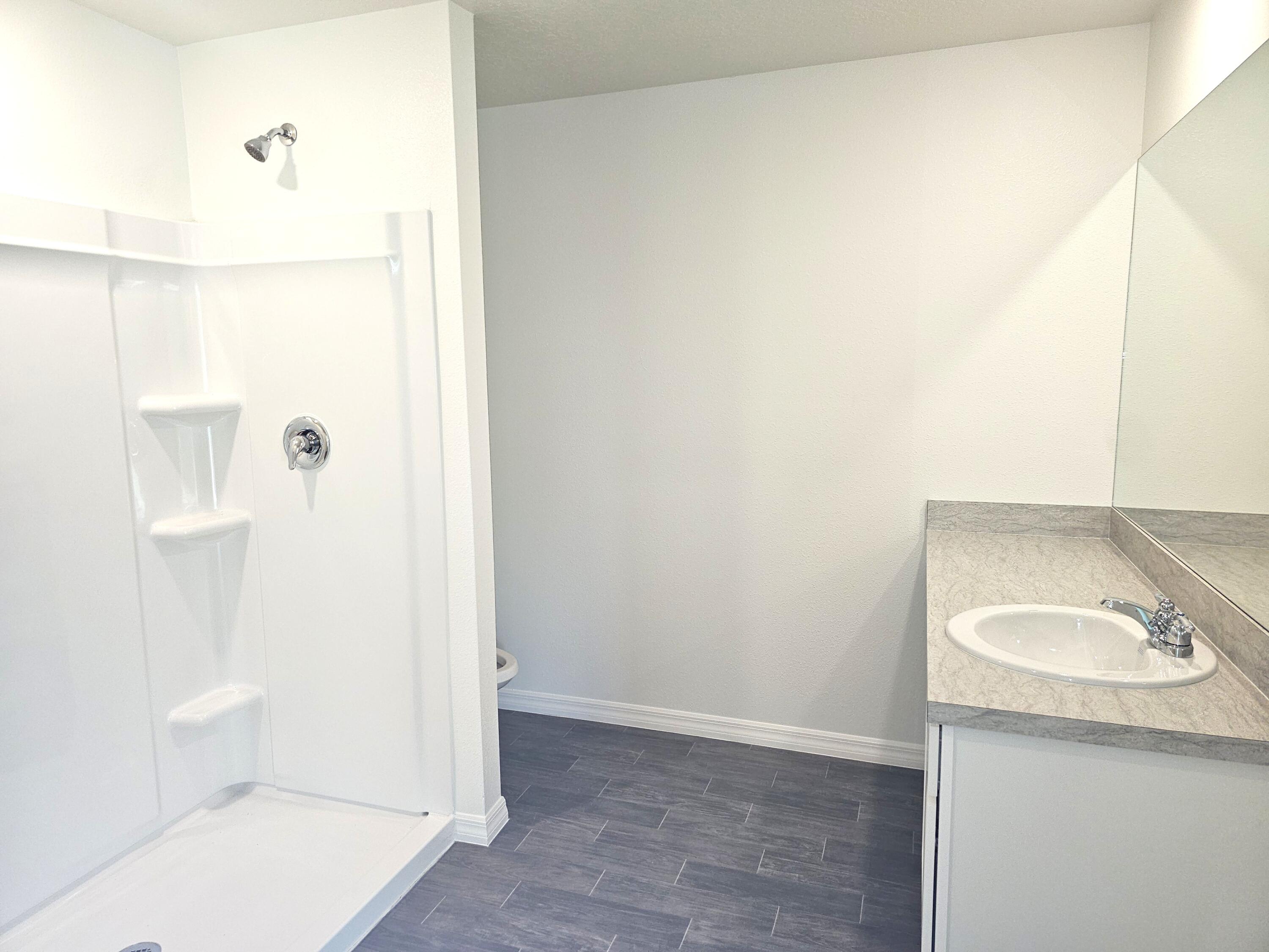 3681 Southwest Haines Street Port St. Lucie, FL 34953 - Photo 7 of 19 a bathroom with a sink a toilet and shower