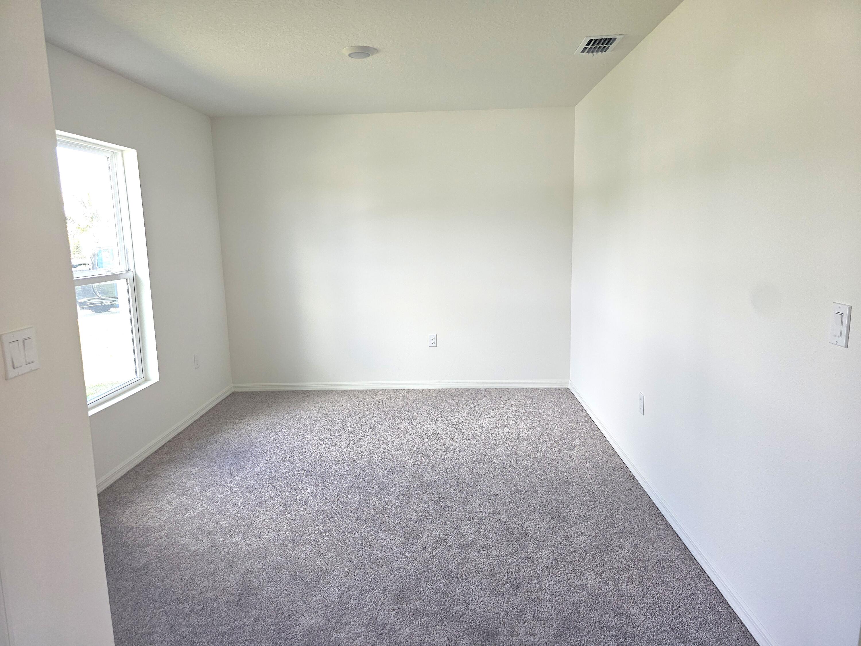 3681 Southwest Haines Street Port St. Lucie, FL 34953 - Photo 9 of 19 an empty room with a window