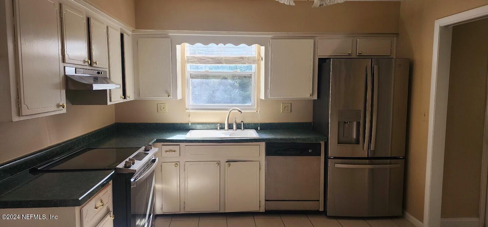 25 Versaggi Drive St. Augustine, FL 32080 - Photo 8 of 23 a kitchen with a refrigerator and a sink