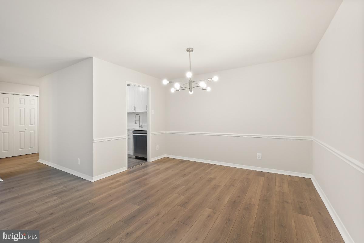 1900 Lyttonsville Road, Unit 216 Silver Spring, MD 20910 - Photo 12 of 38 a view of a room with wooden floor and kitchen