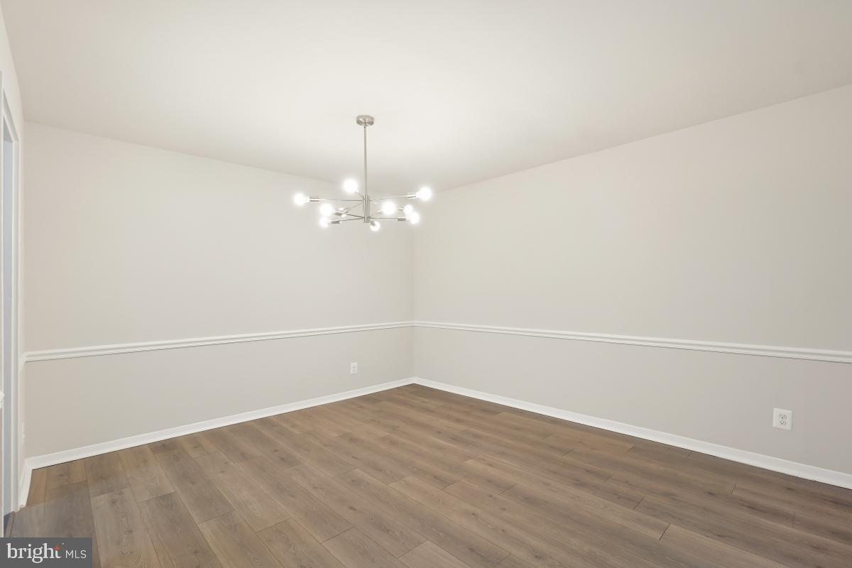 1900 Lyttonsville Road, Unit 216 Silver Spring, MD 20910 - Photo 14 of 38 a view of a room with wooden floor and ceiling fan