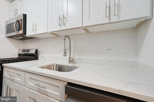 a kitchen with a stove and a sink