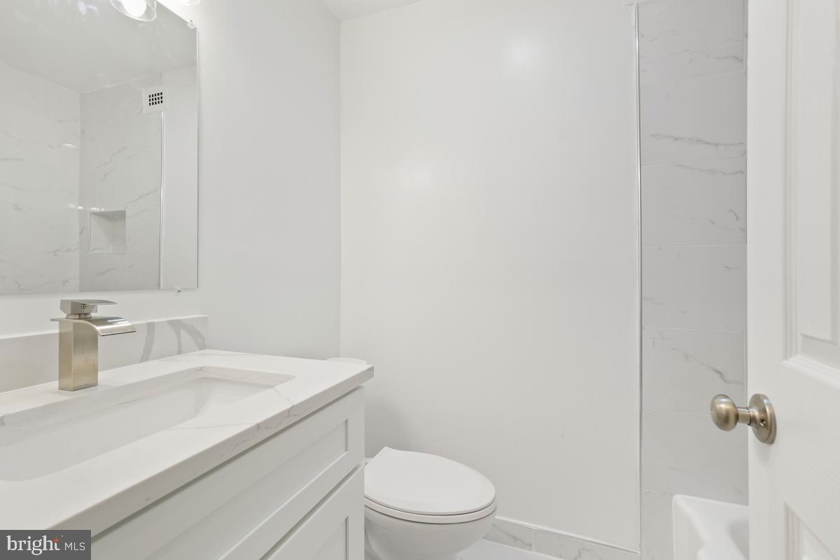 1900 Lyttonsville Road, Unit 216 Silver Spring, MD 20910 - Photo 19 of 38 a bathroom with a sink toilet vanity and shower