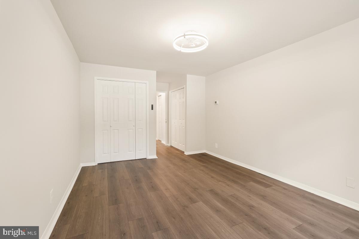 1900 Lyttonsville Road, Unit 216 Silver Spring, MD 20910 - Photo 24 of 38 a view of an empty room and wooden floor