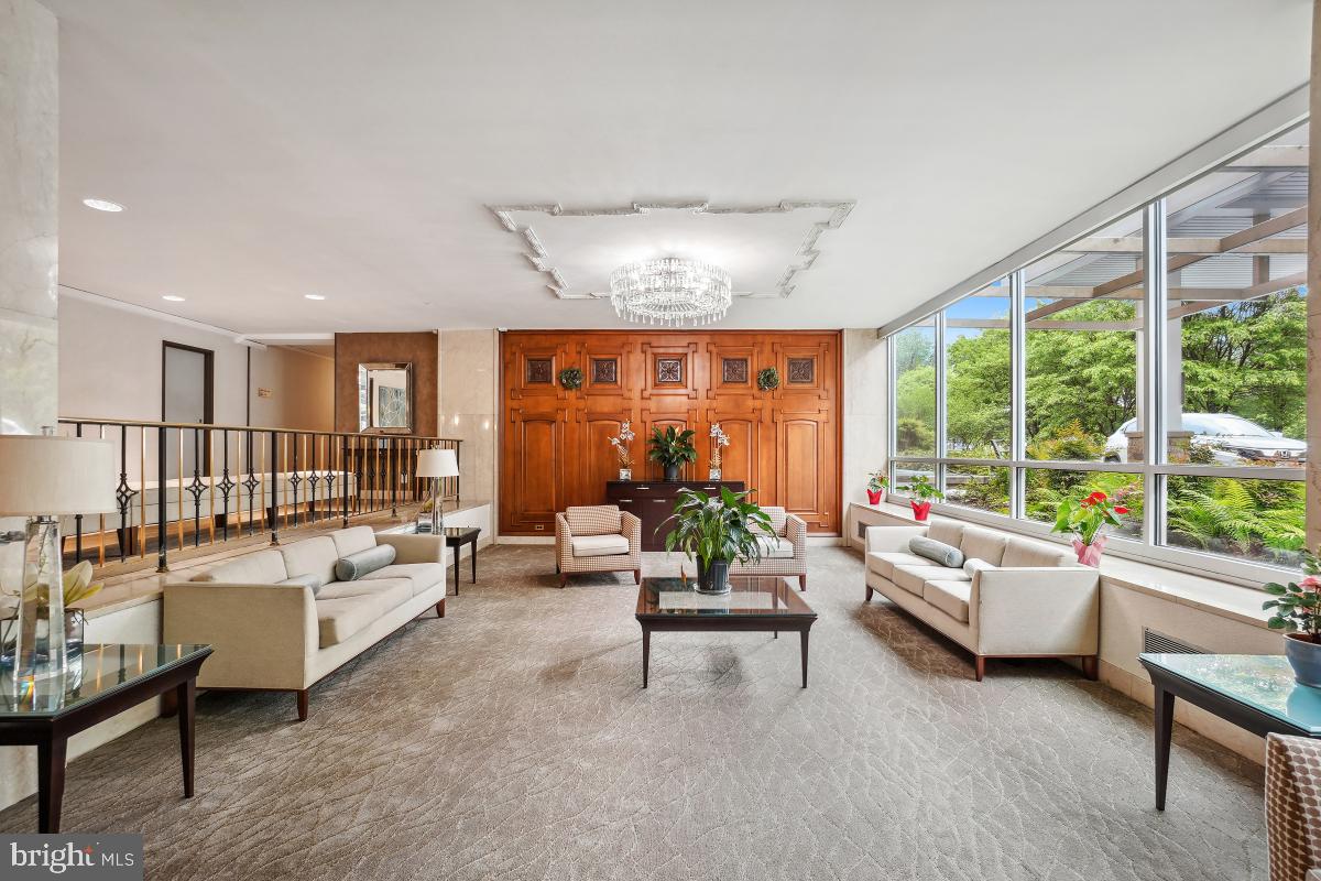 1900 Lyttonsville Road, Unit 216 Silver Spring, MD 20910 - Photo 3 of 38 a living room with furniture and a large window