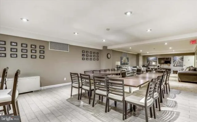 a dining room with furniture and wooden floor