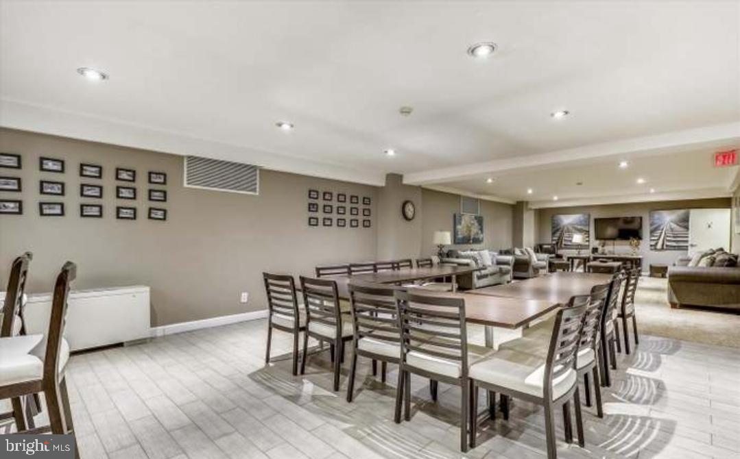 1900 Lyttonsville Road, Unit 216 Silver Spring, MD 20910 - Photo 31 of 38 a view of a dining room with furniture and wooden floor