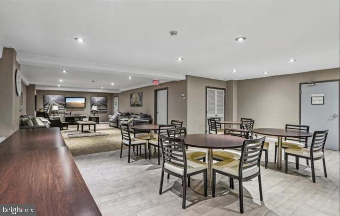 1900 Lyttonsville Road, Unit 216 Silver Spring, MD 20910 - Photo 32 of 38 a dining room with furniture and wooden floor