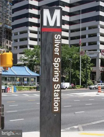 a front view of multi story residential apartment building with retail shops