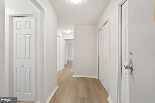 a view of a hallway with wooden floor