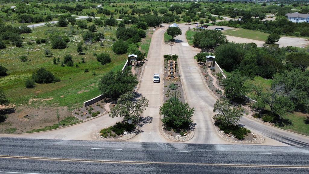 an aerial view of a house with a yard and parking spaces