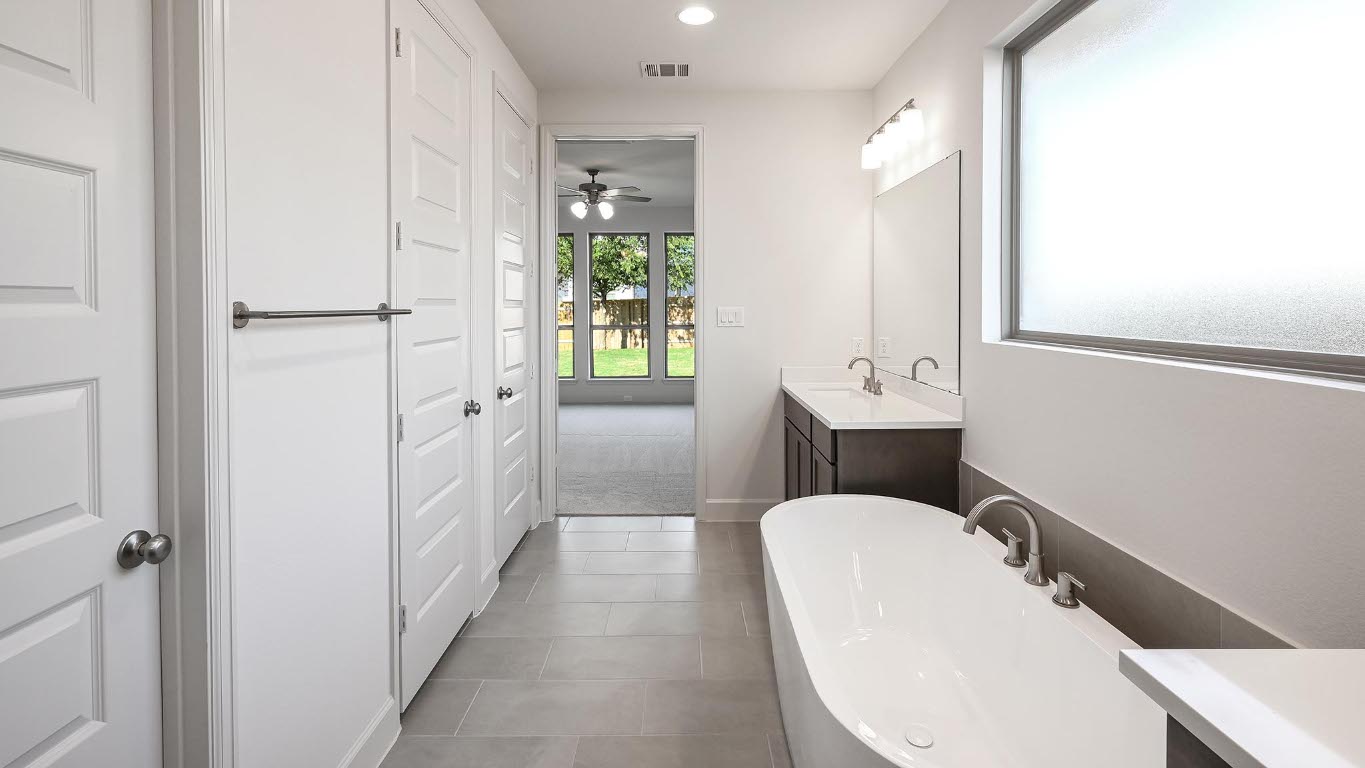 523 Prickly Poppy Loop Kyle, TX 78640 - Photo 11 of 40 Bathroom featuring vanity, a soaking tub, dark tile patterned flooring, ceiling fan, and recessed lighting