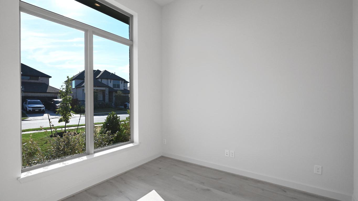 523 Prickly Poppy Loop Kyle, TX 78640 - Photo 12 of 40 Unfurnished room featuring baseboards and wood finished floors