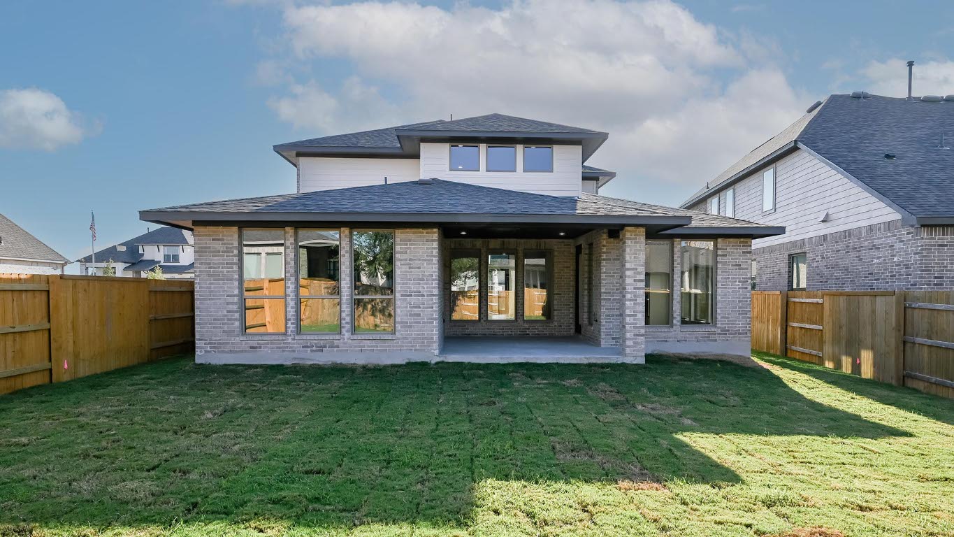 523 Prickly Poppy Loop Kyle, TX 78640 - Photo 13 of 40 Rear view of property featuring a fenced backyard, a patio, brick siding, and a shingled roof