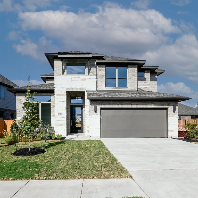 523 Prickly Poppy Loop Kyle, TX 78640 - Photo 2 of 40 View of front of home featuring an attached garage, stone siding, brick siding, and concrete driveway