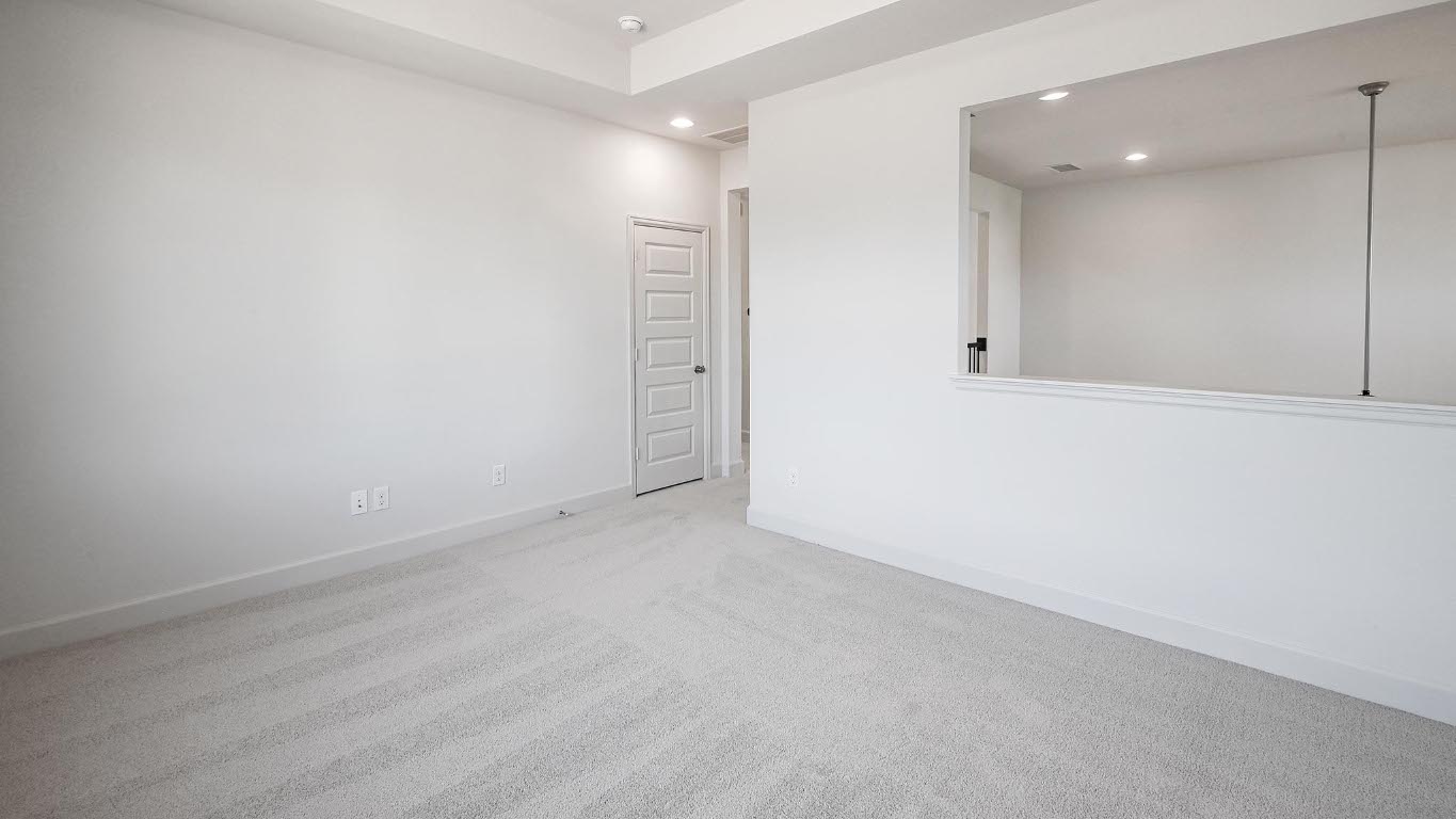 523 Prickly Poppy Loop Kyle, TX 78640 - Photo 22 of 40 Carpeted empty room with baseboards and recessed lighting