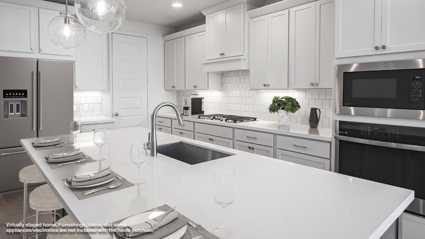 523 Prickly Poppy Loop Kyle, TX 78640 - Photo 4 of 40 Kitchen featuring a kitchen breakfast bar, appliances with stainless steel finishes, backsplash, hanging light fixtures, and white cabinets