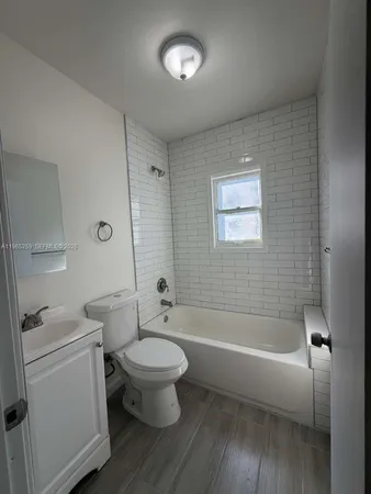 a bathroom with a toilet a sink and bathtub