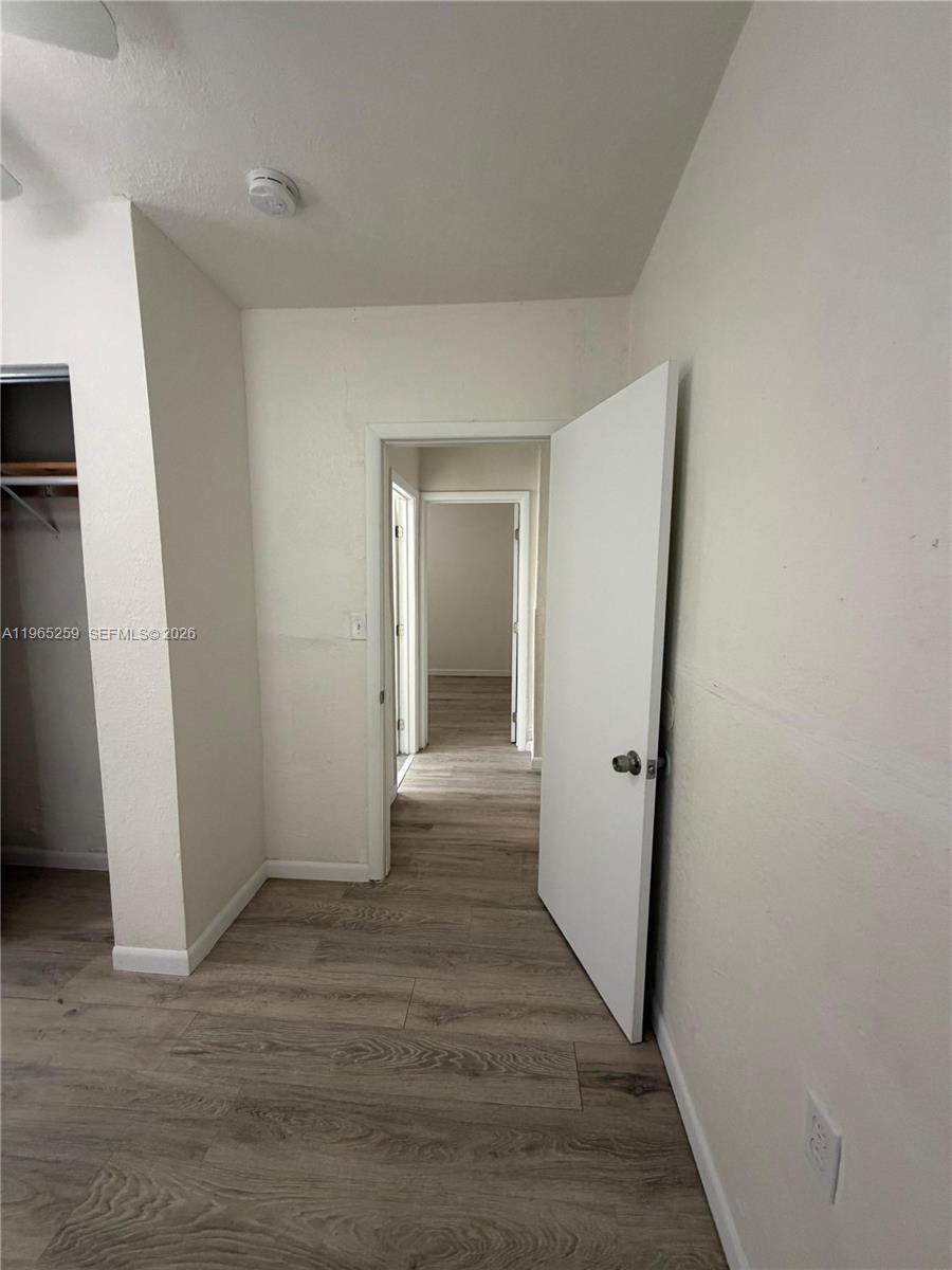 140 Northwest 13th Street, Unit 154 Miami, FL 33136 - Photo 15 of 18 a view of a hallway with wooden floor