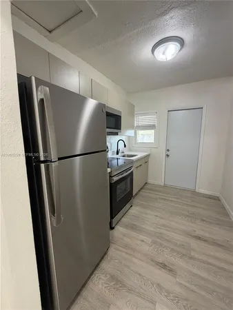 a kitchen with stainless steel appliances a refrigerator a sink and a stove