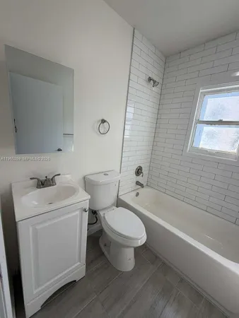 a bathroom with a toilet sink and bathtub