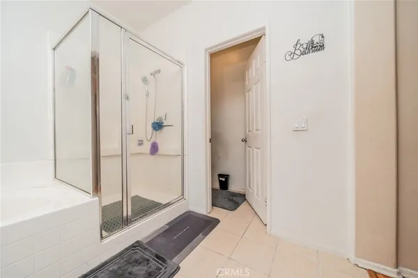 a bathroom with a shower and a glass door