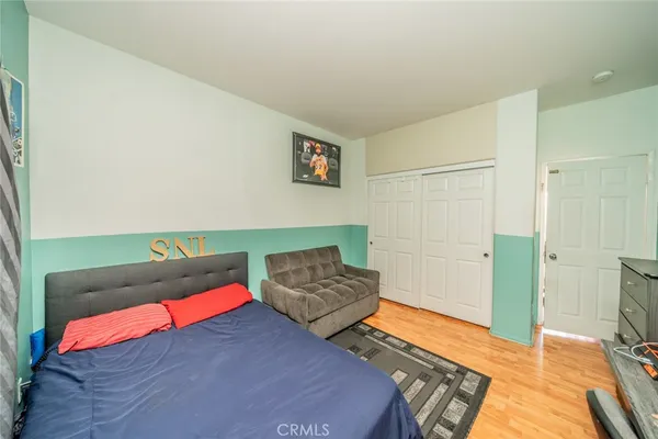 a bedroom with two beds and painted walls