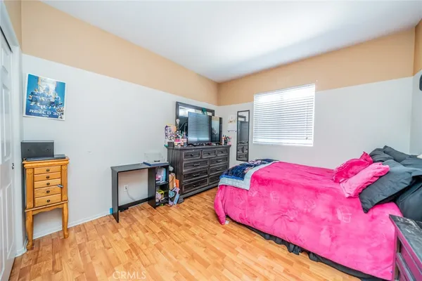 a bedroom with a bed and a lamp