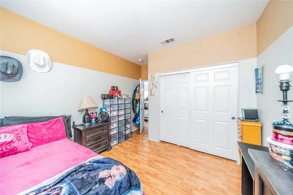 a bedroom with a bed and a dresser