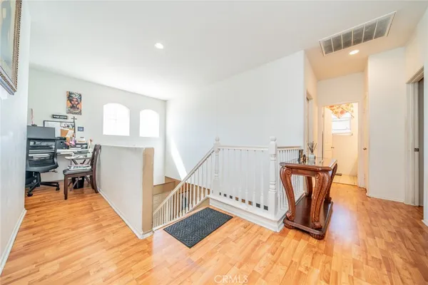 a view of a livingroom with wooden floor and furniture