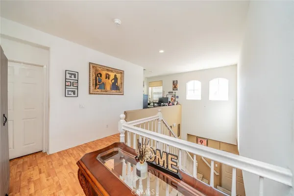 a view of a bedroom with wooden floor