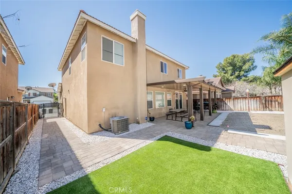 a view of a house with backyard porch and sitting area