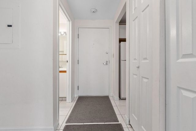 a view of a hallway with wooden shelves