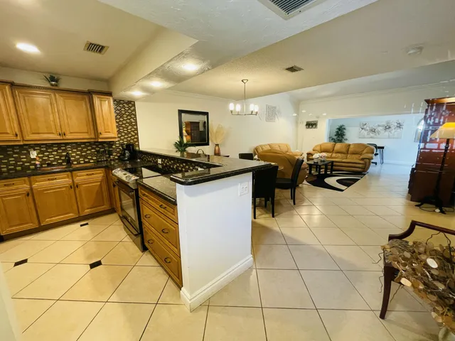a kitchen with stainless steel appliances a stove a sink and a refrigerator