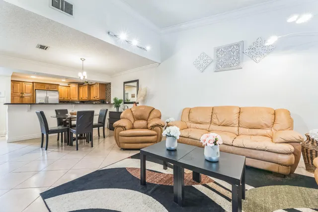 a living room with furniture potted plant and a window