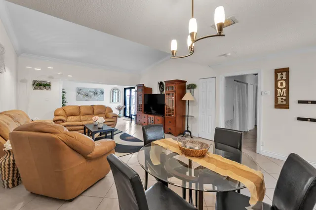 a living room with furniture a lamp and a chandelier