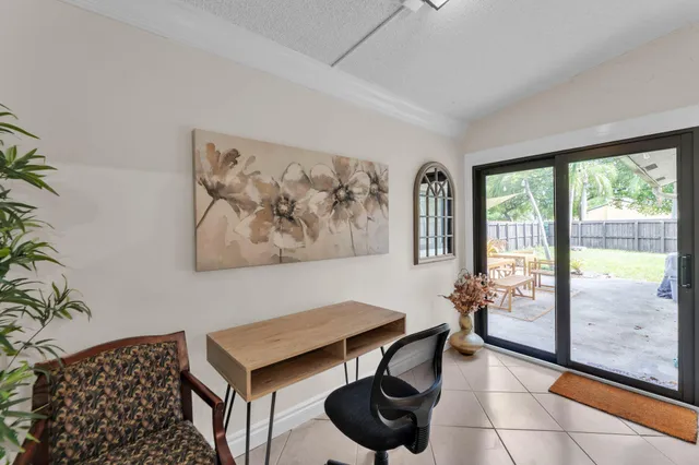 a living room with furniture and a floor to ceiling window